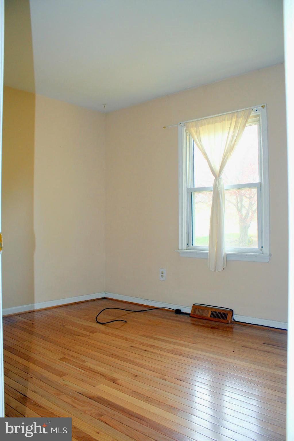 2416 Raintree Avenue Westminster, MD 21157 - Photo 20 of 27 an empty room with wooden floor and windows