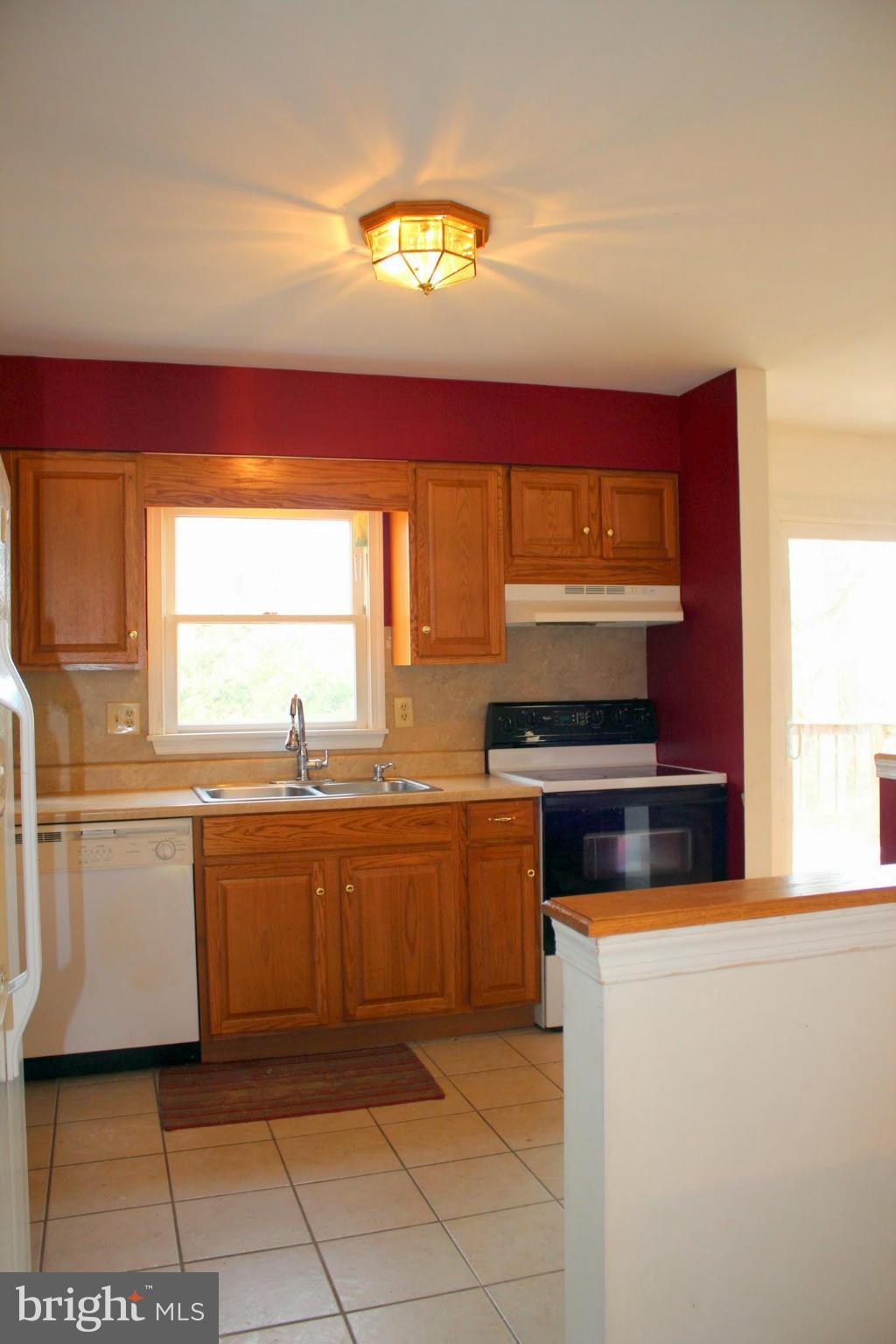 2416 Raintree Avenue Westminster, MD 21157 - Photo 8 of 27 a kitchen with stainless steel appliances granite countertop a stove a sink and a microwave