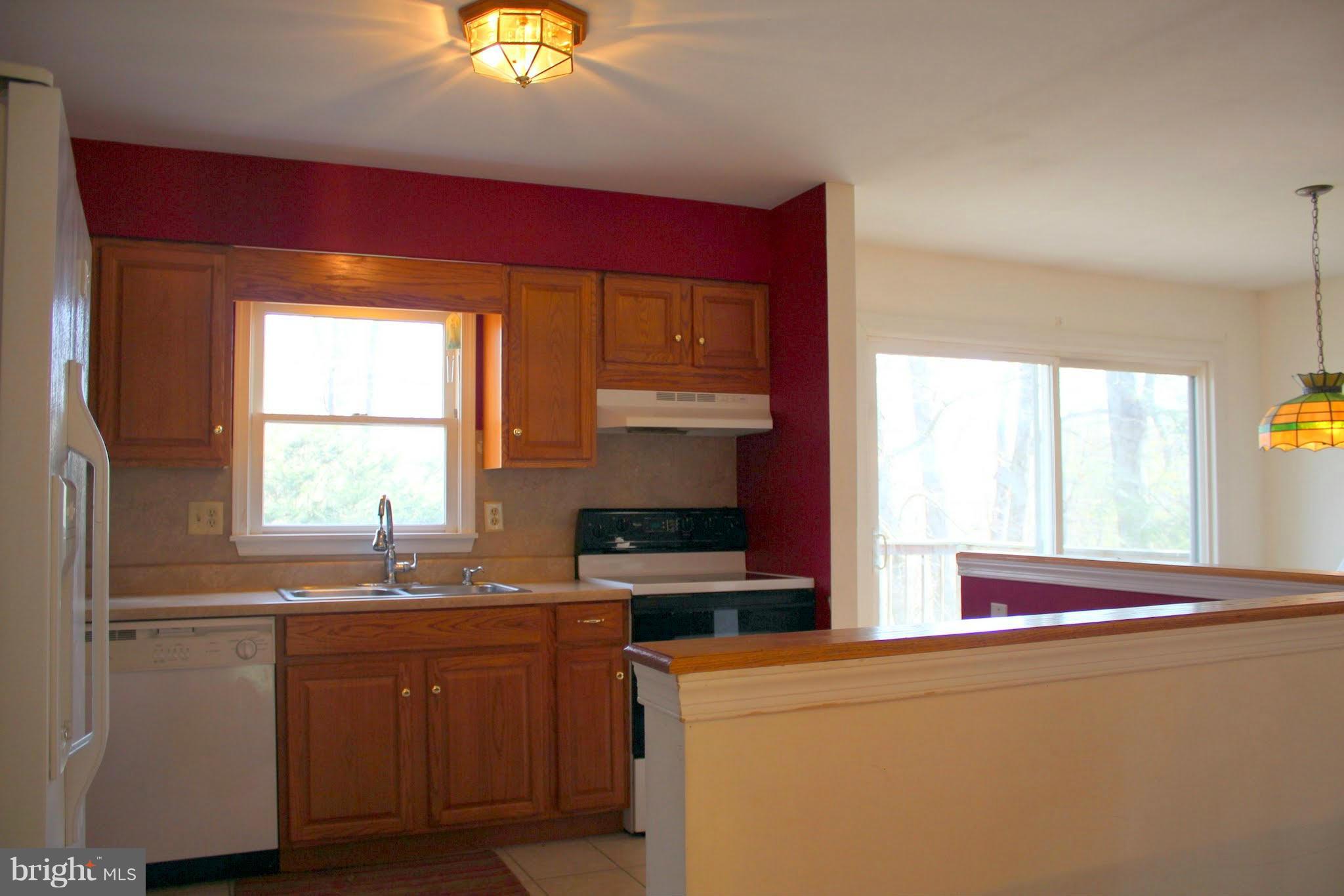 2416 Raintree Avenue Westminster, MD 21157 - Photo 9 of 27 a kitchen with stainless steel appliances granite countertop a sink a stove and a refrigerator