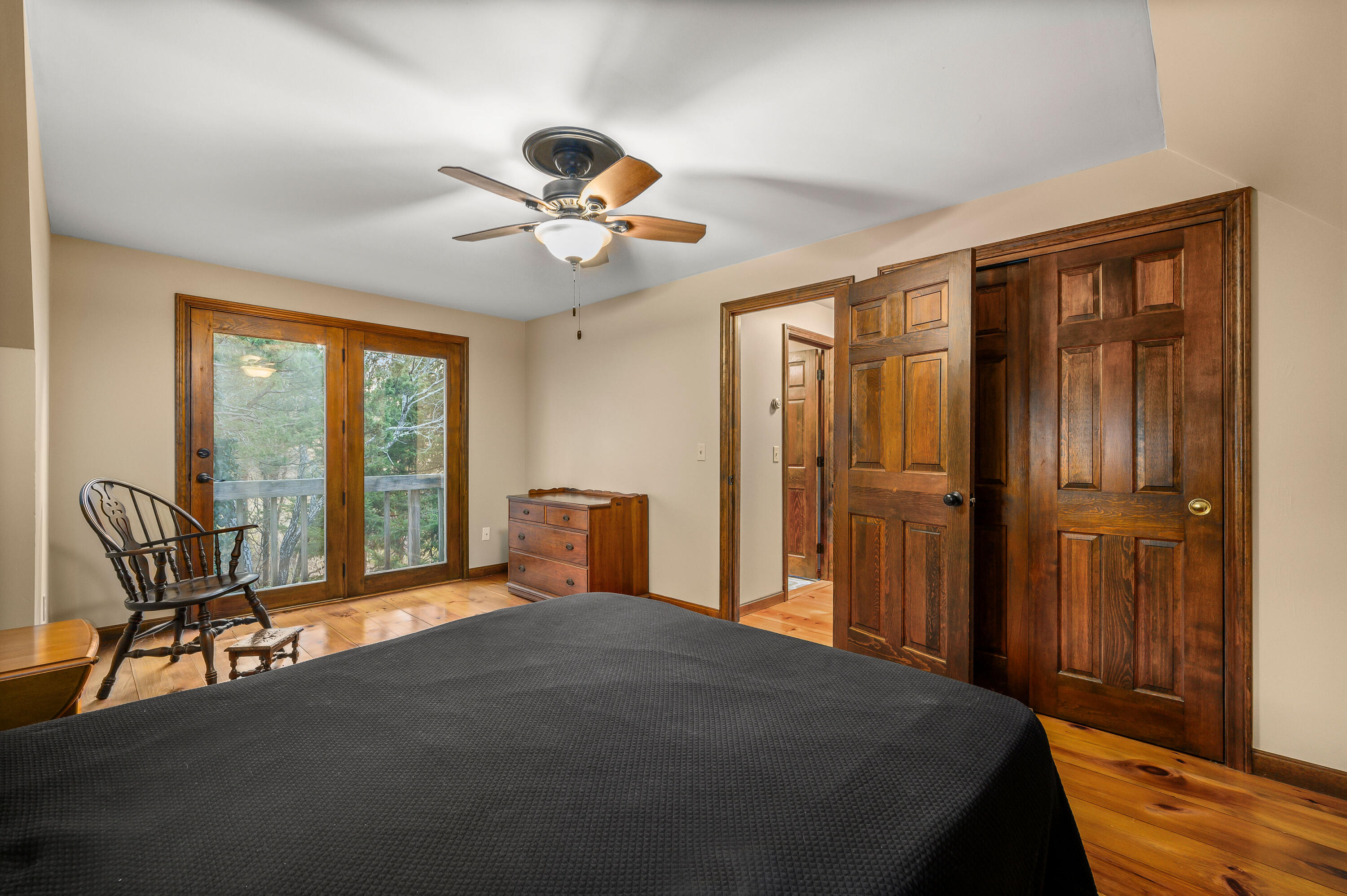 24 Blueberry Island Road Orleans, MA 02653 - Photo 18 of 39 a bedroom with a bed and a chandelier