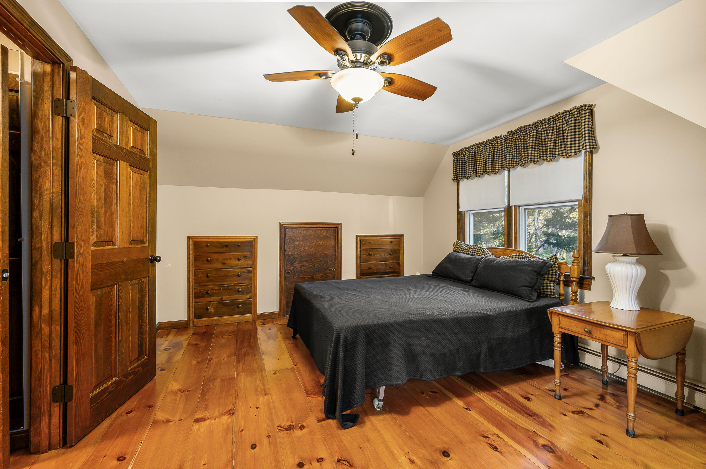 24 Blueberry Island Road Orleans, MA 02653 - Photo 19 of 39 a bedroom with a bed and wooden floor