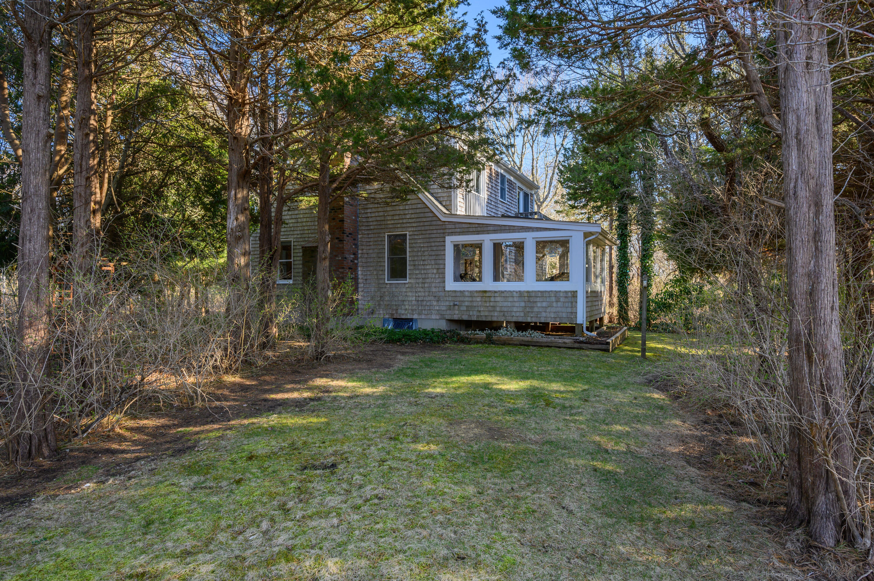 24 Blueberry Island Road Orleans, MA 02653 - Photo 24 of 39 front view of a house with a yard