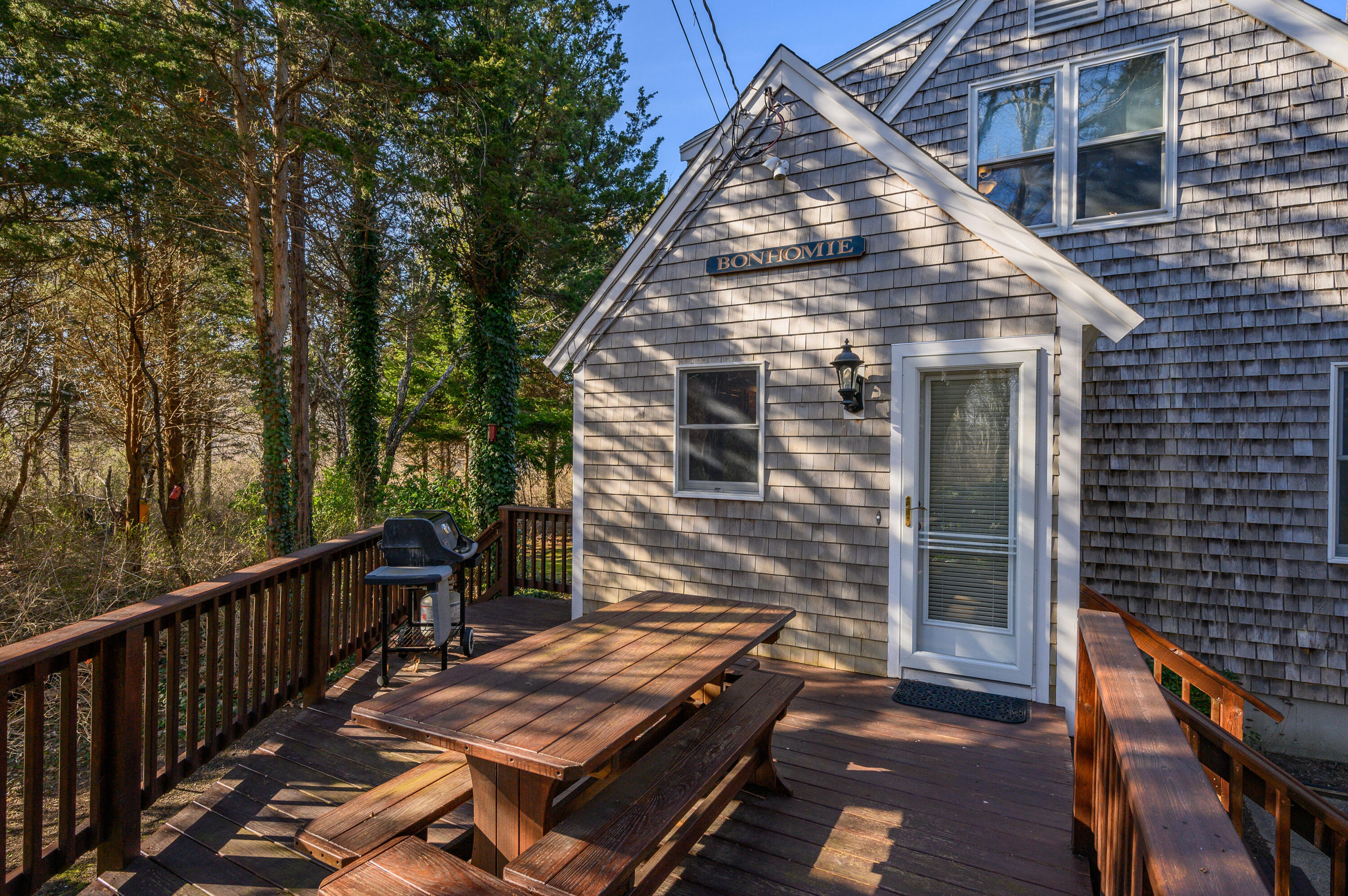 24 Blueberry Island Road Orleans, MA 02653 - Photo 26 of 39 a view of a wooden deck next to a yard