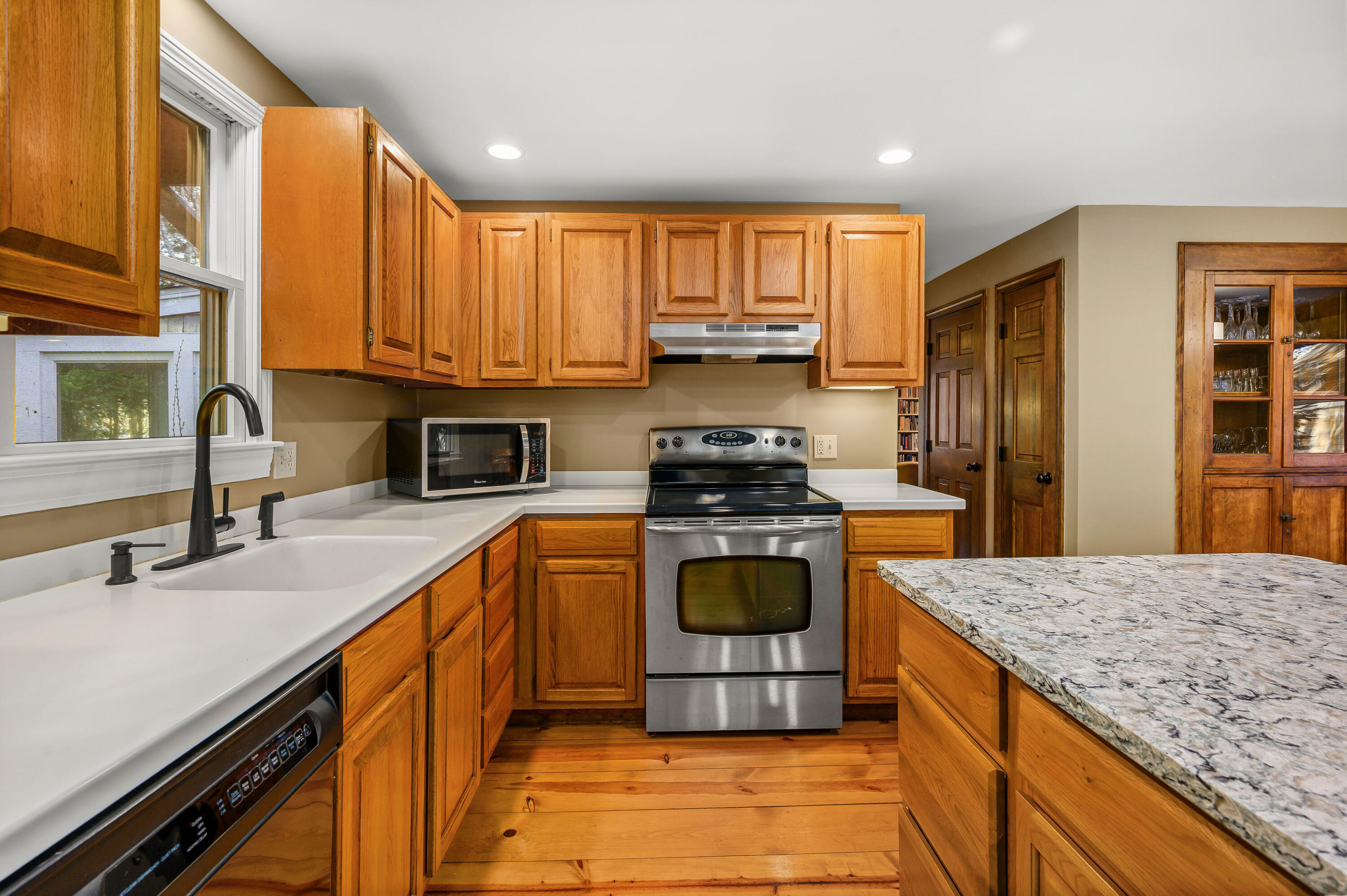 24 Blueberry Island Road Orleans, MA 02653 - Photo 7 of 39 a kitchen with stainless steel appliances granite countertop a stove a sink and a refrigerator