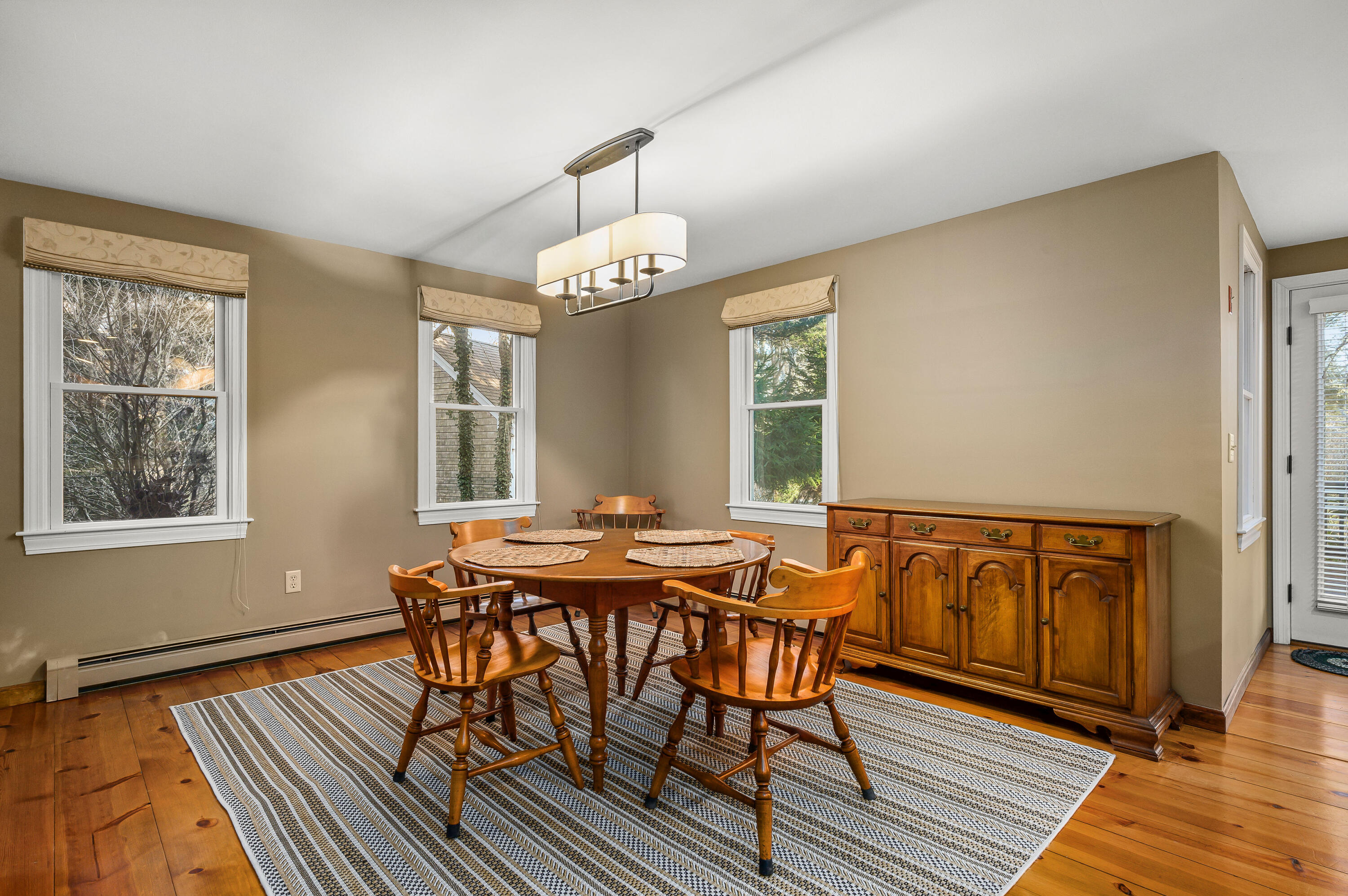 24 Blueberry Island Road Orleans, MA 02653 - Photo 9 of 39 a view of a dining room with furniture window and wooden floor
