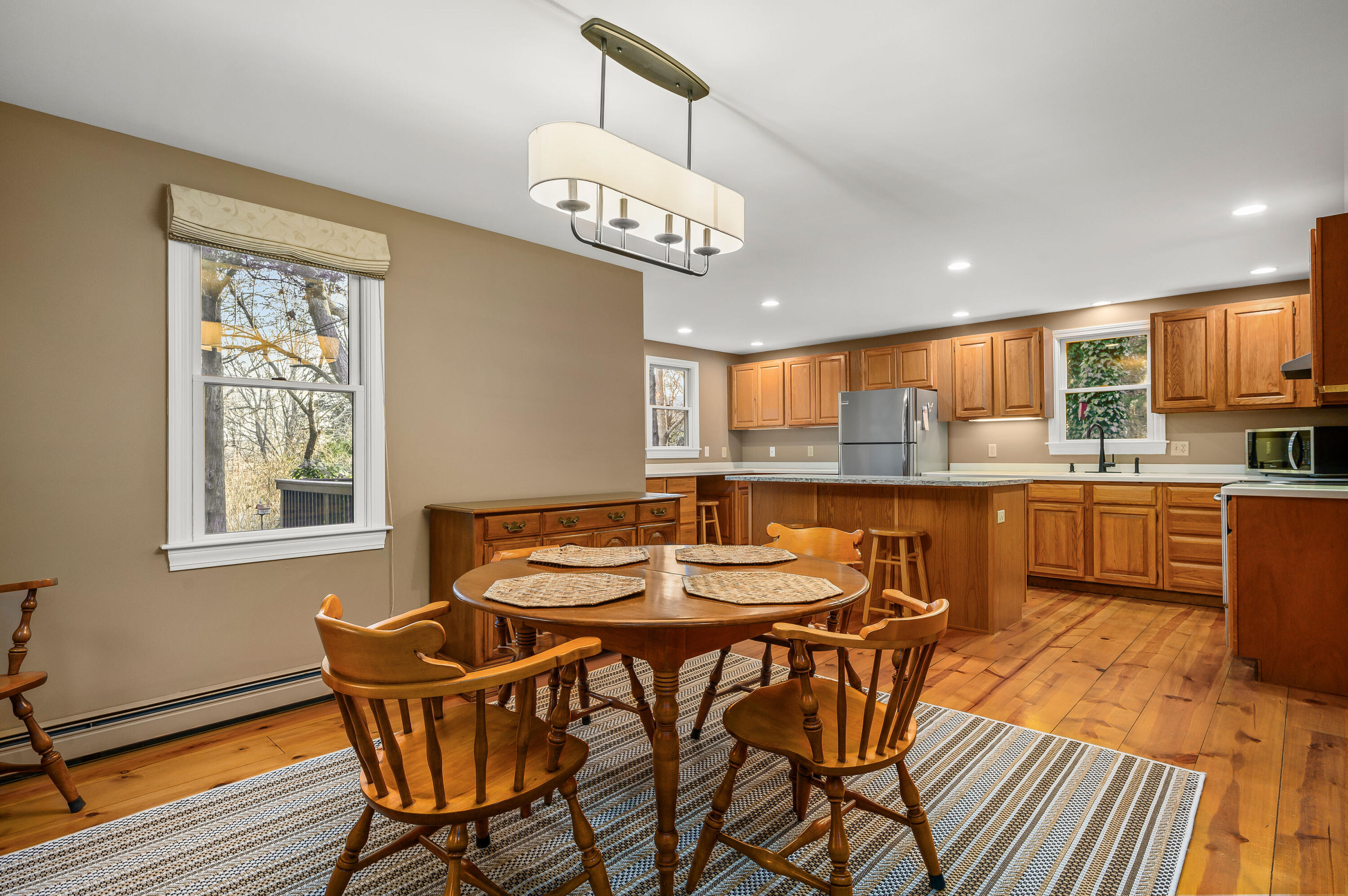 24 Blueberry Island Road Orleans, MA 02653 - Photo 10 of 39 a view of a dining room with furniture a kitchen and chandelier