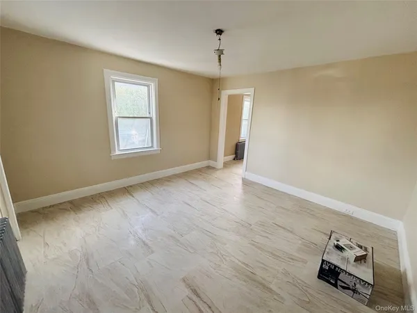 a view of livingroom with hardwood floor and window in a room