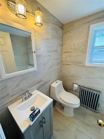 a bathroom with a sink a toilet and mirror