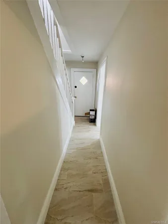 a view of a hallway with white walls