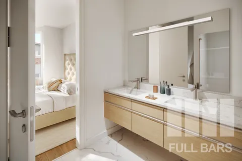 a en suite bathroom with a double vanity sink and mirror
