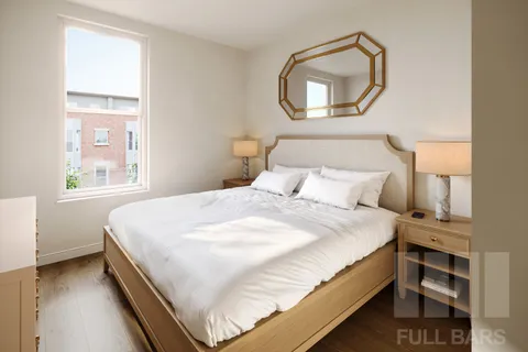 a bedroom with a bed and a window