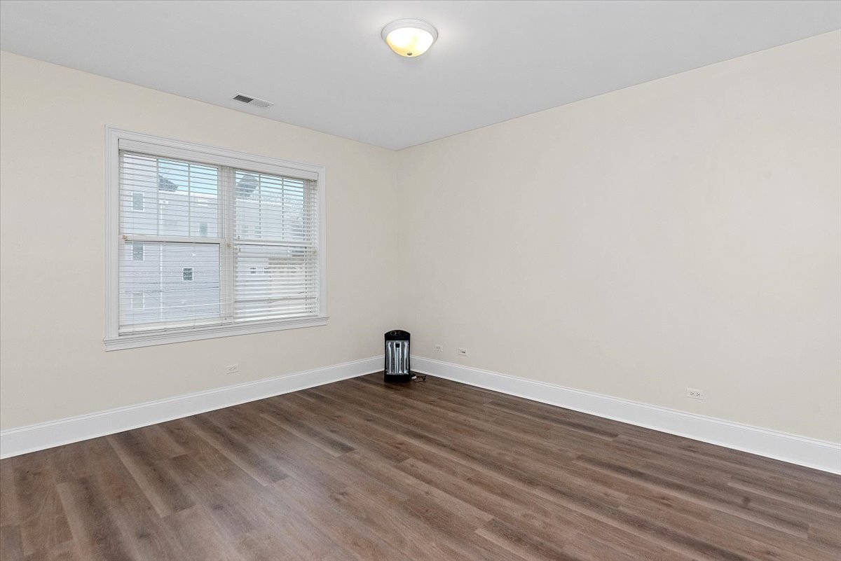 2500 Green Bay Road, Unit 403 Evanston, IL 60201 - Photo 9 of 16 an empty room with wooden floor and windows