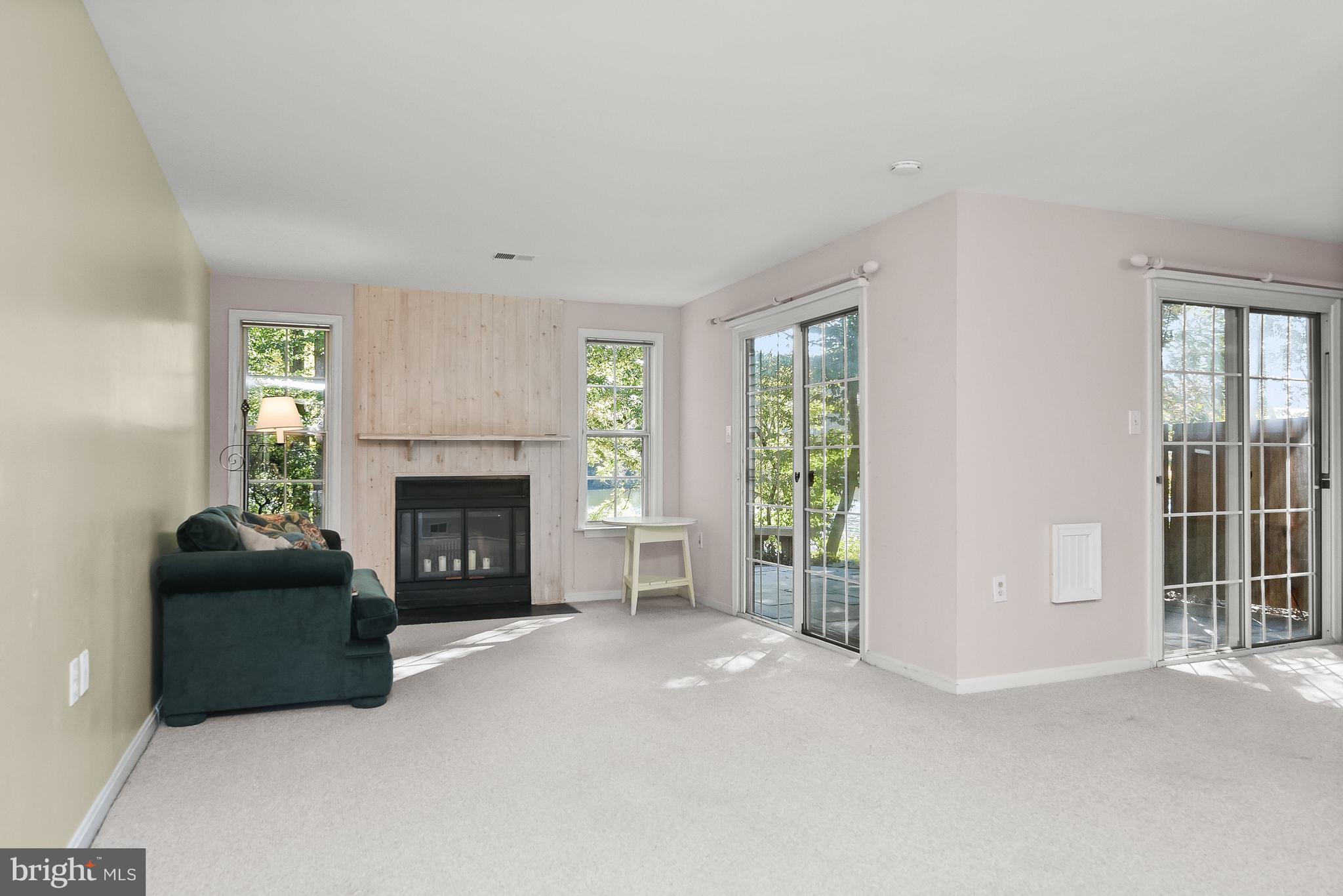 7369 Swan Point Way, Unit 109 Columbia, MD 21045 - Photo 7 of 65 Walkout recreation room with wood burning fireplac