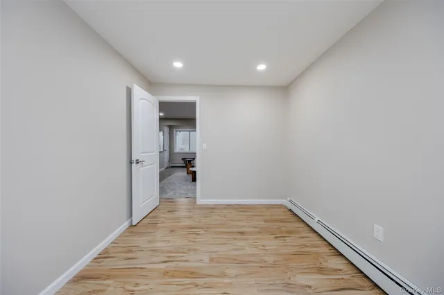 a view of hallway with wooden floor
