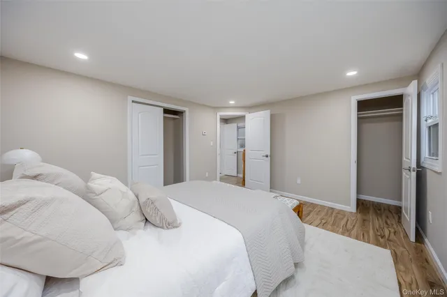 a spacious bedroom with a bed and a couch