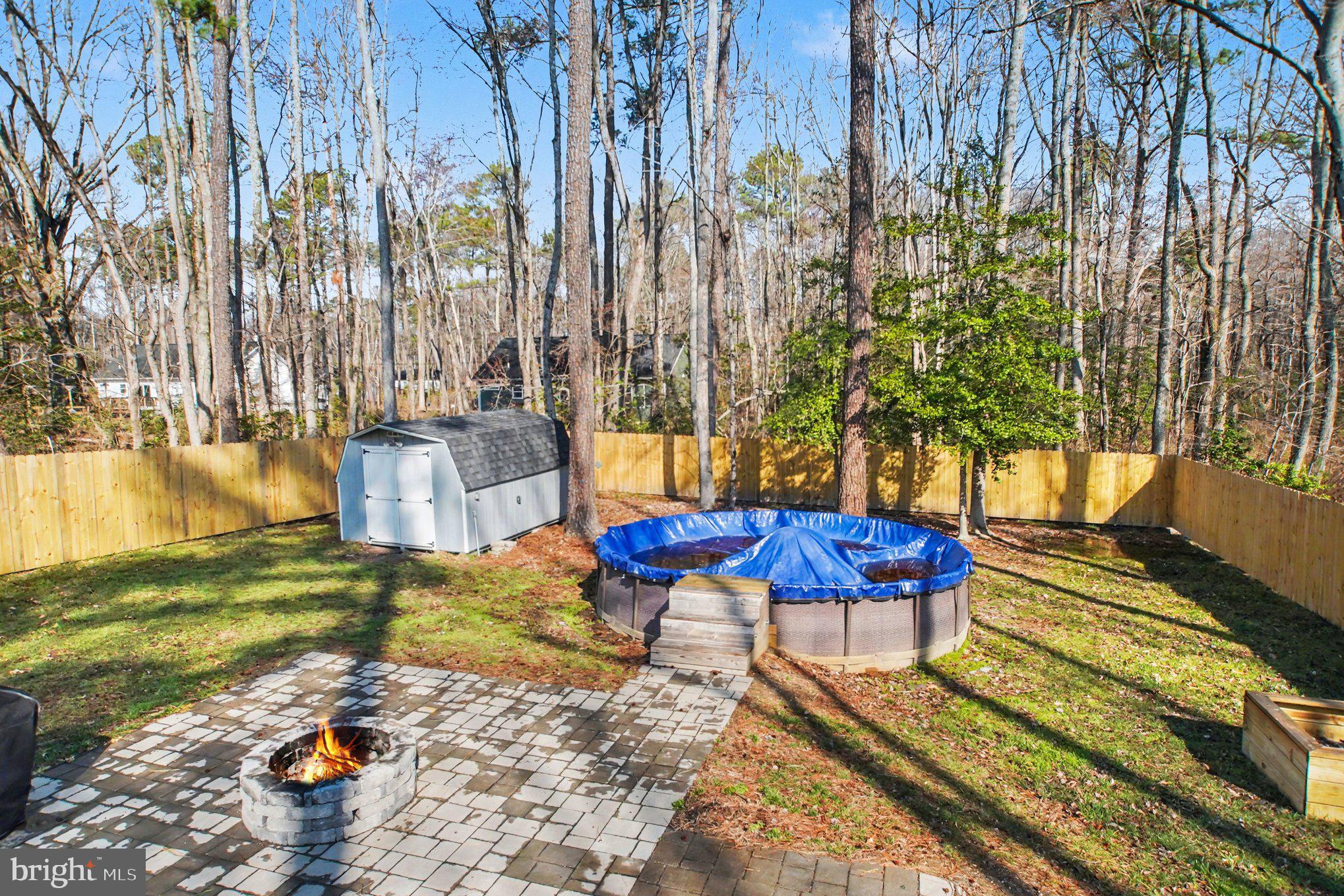 261 Azure Drive Colonial Beach, VA 22443 - Photo 26 of 44 Fenced backyard with fire pit, shed, and pool