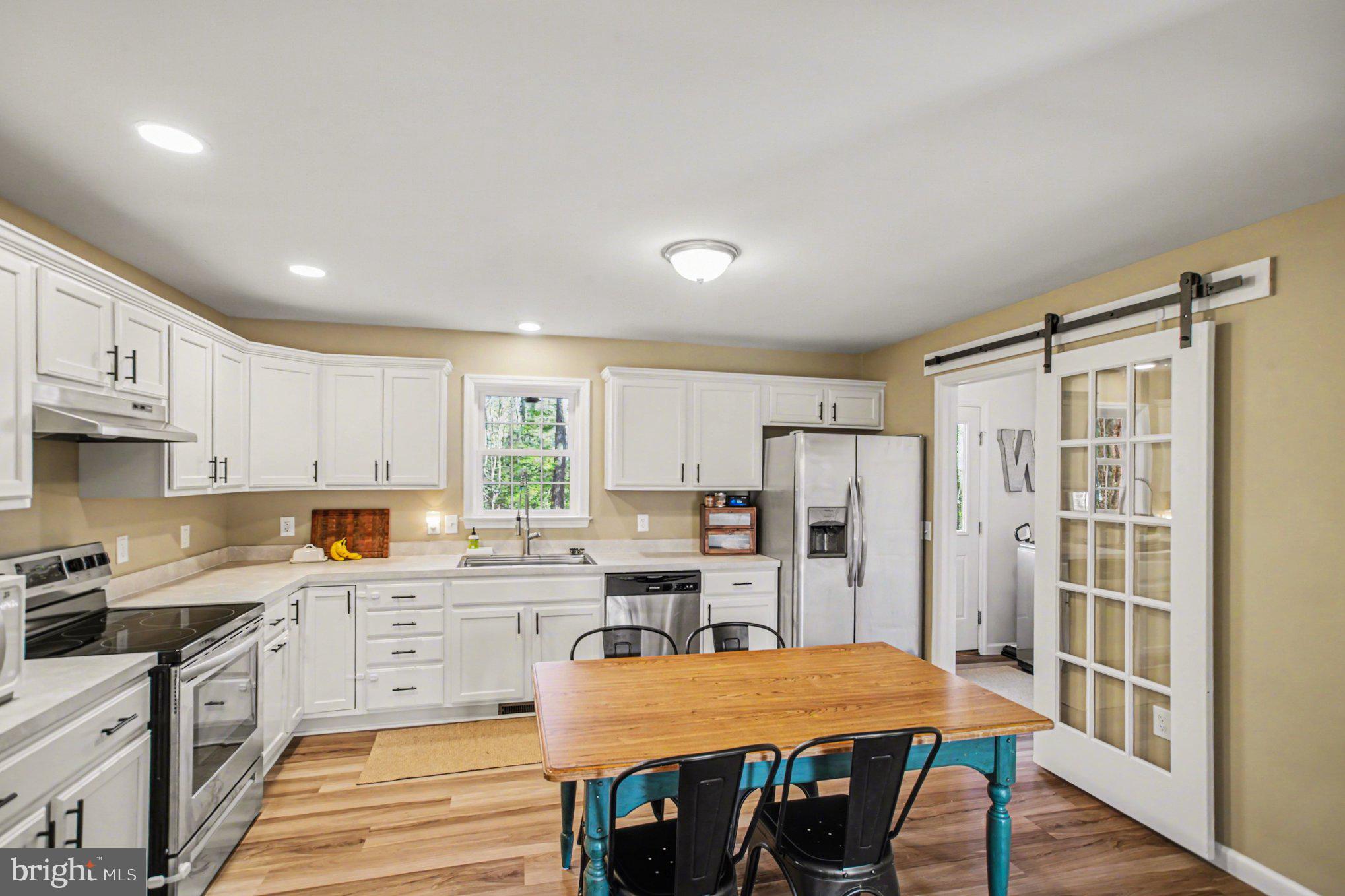 261 Azure Drive Colonial Beach, VA 22443 - Photo 3 of 44 Bright kitchen with glass barn door to laundry rm