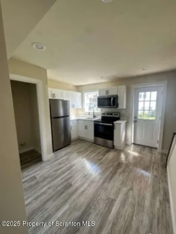 a view of a kitchen with a sink and a stove top oven