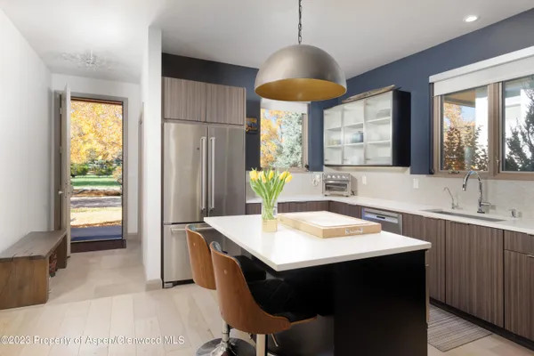 a kitchen with a table chairs and sink