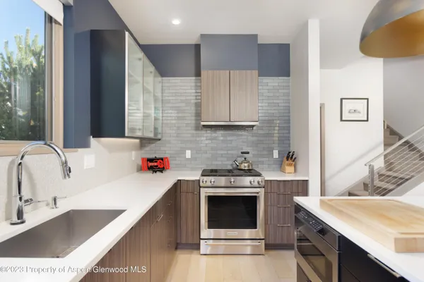 a kitchen with a sink stove and cabinets