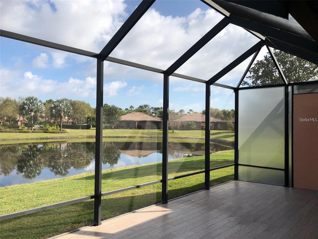 140 Shell Falls Drive Apollo Beach, FL 33572 - Photo 11 of 20 a view of a porch with a floor to ceiling window next to a yard
