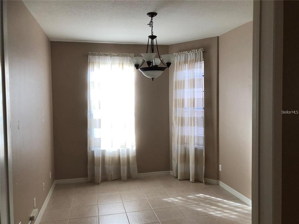 140 Shell Falls Drive Apollo Beach, FL 33572 - Photo 8 of 20 a view of a hallway with windows and chandelier