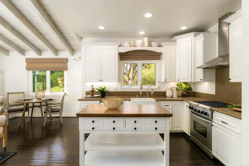 17543 Via Del Bravo Rancho Santa Fe, CA 92067 - Photo 14 of 41 a large white kitchen with lots of counter space a sink and appliances