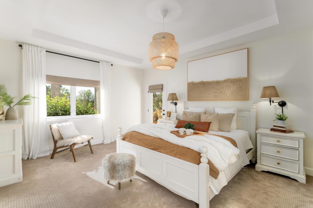 17543 Via Del Bravo Rancho Santa Fe, CA 92067 - Photo 16 of 41 a bedroom with a bed and a chandelier