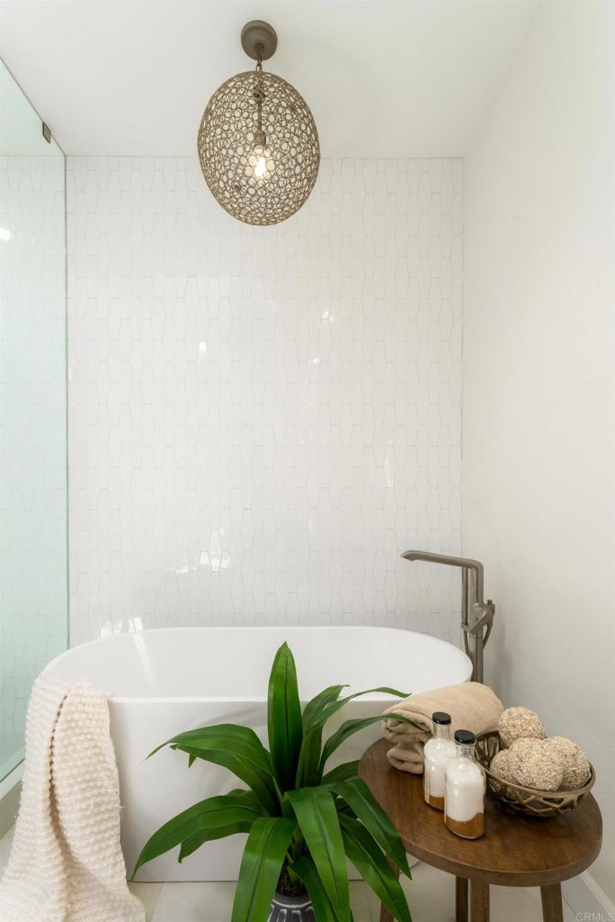 17543 Via Del Bravo Rancho Santa Fe, CA 92067 - Photo 18 of 41 a bedroom with a bed and a chandelier