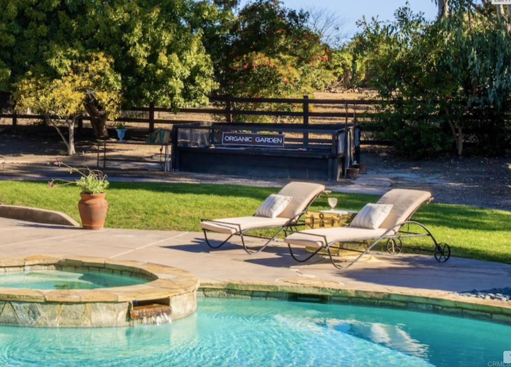 17543 Via Del Bravo Rancho Santa Fe, CA 92067 - Photo 28 of 41 a view of swimming pool with seating area and trees in the background