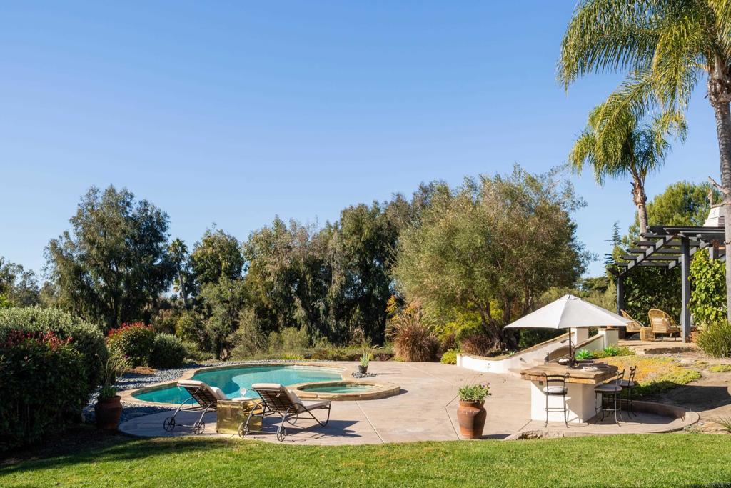 17543 Via Del Bravo Rancho Santa Fe, CA 92067 - Photo 32 of 41 a view of a house with swimming pool and sitting area