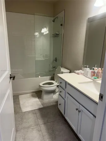 a bathroom with a double vanity sink toilet mirror and shower