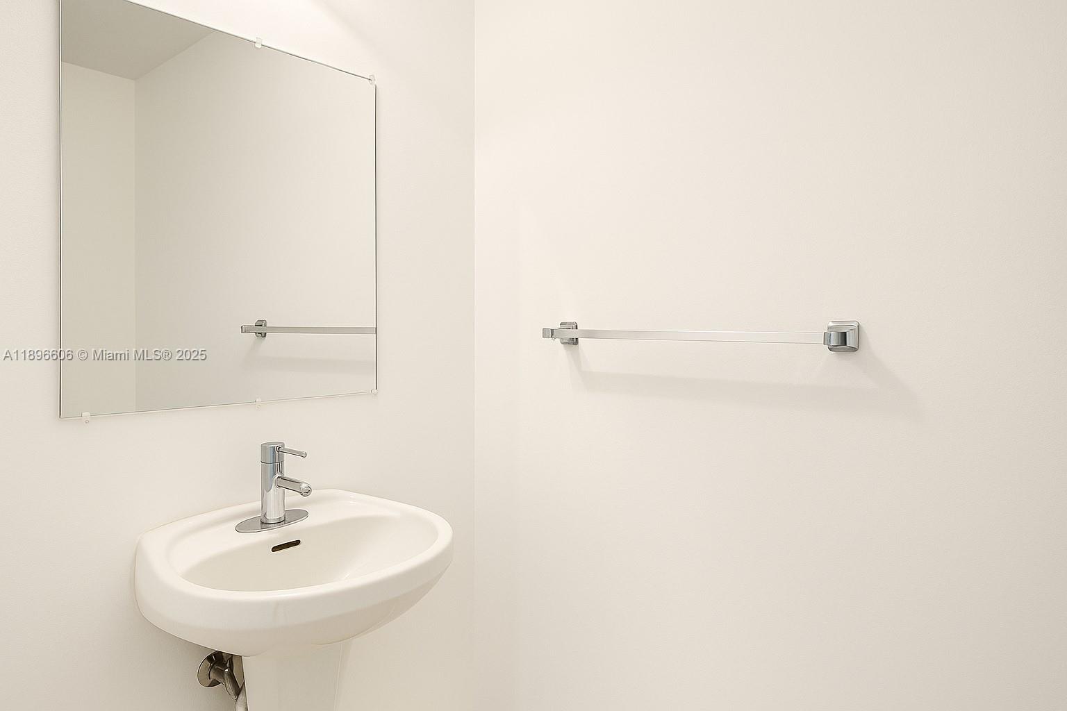 60 Southwest 13th Street, Unit 3418 Miami, FL 33130 - Photo 14 of 16 a bathroom with a sink and a mirror