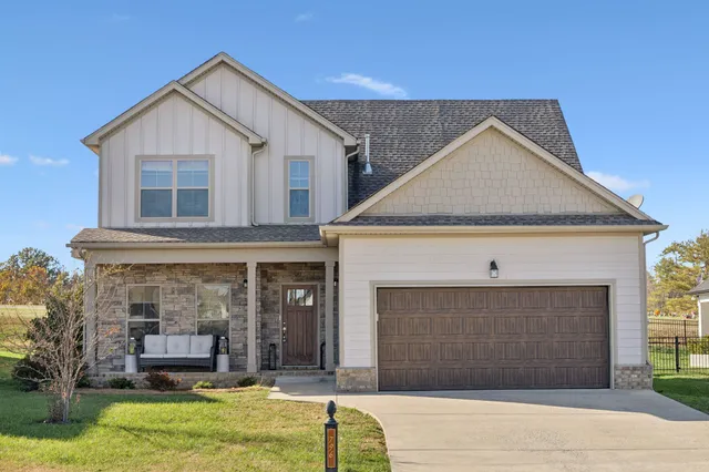 a front view of a house with a yard and garage