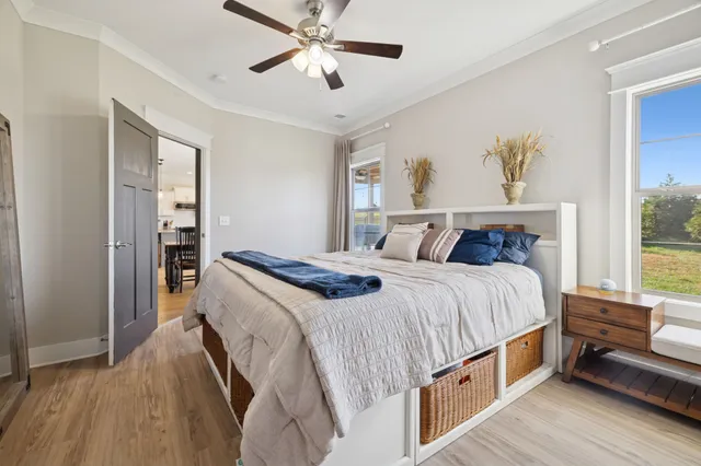 a bedroom with a large bed and a chandelier
