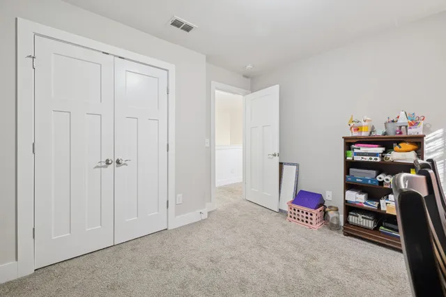 a view of a bedroom with closet and cabinet