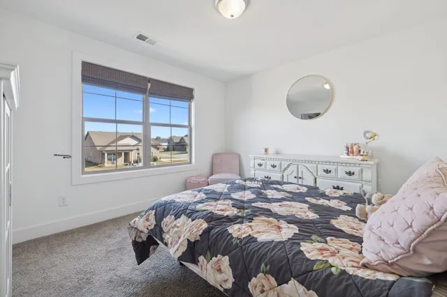 a bedroom with a bed and window