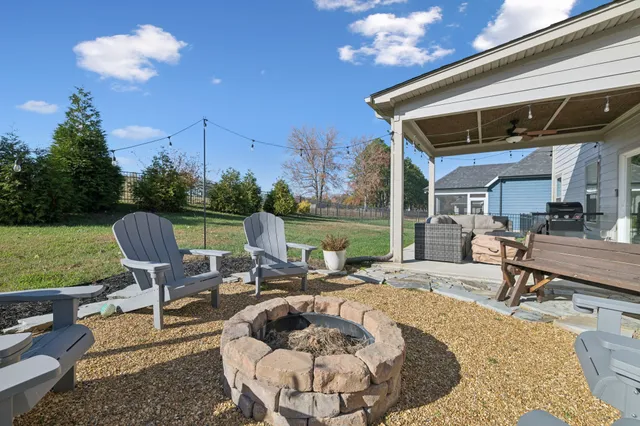 a view of a backyard with sitting area furniture and garden