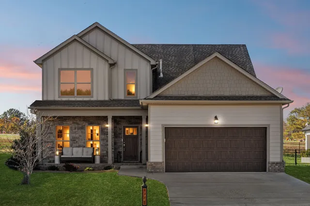 a front view of a house with a yard and garage