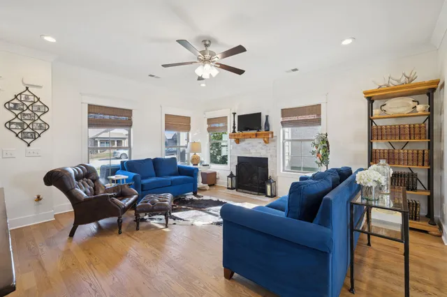 a living room with furniture a fireplace and a flat screen tv