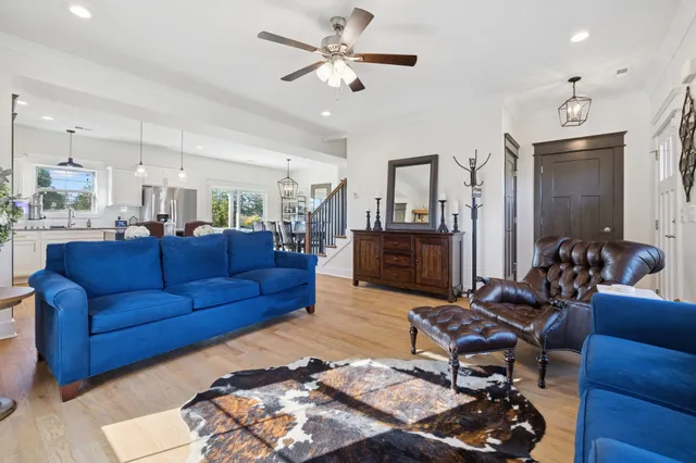 a living room with furniture wooden floor and a chandelier