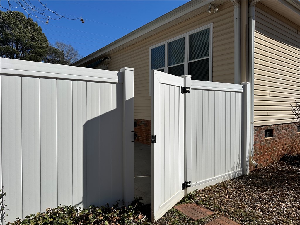 112 Jester Court Williamston, SC 29697 - Photo 34 of 35 This outdoor space features a secure fence and gate, complementing the home's exterior.
