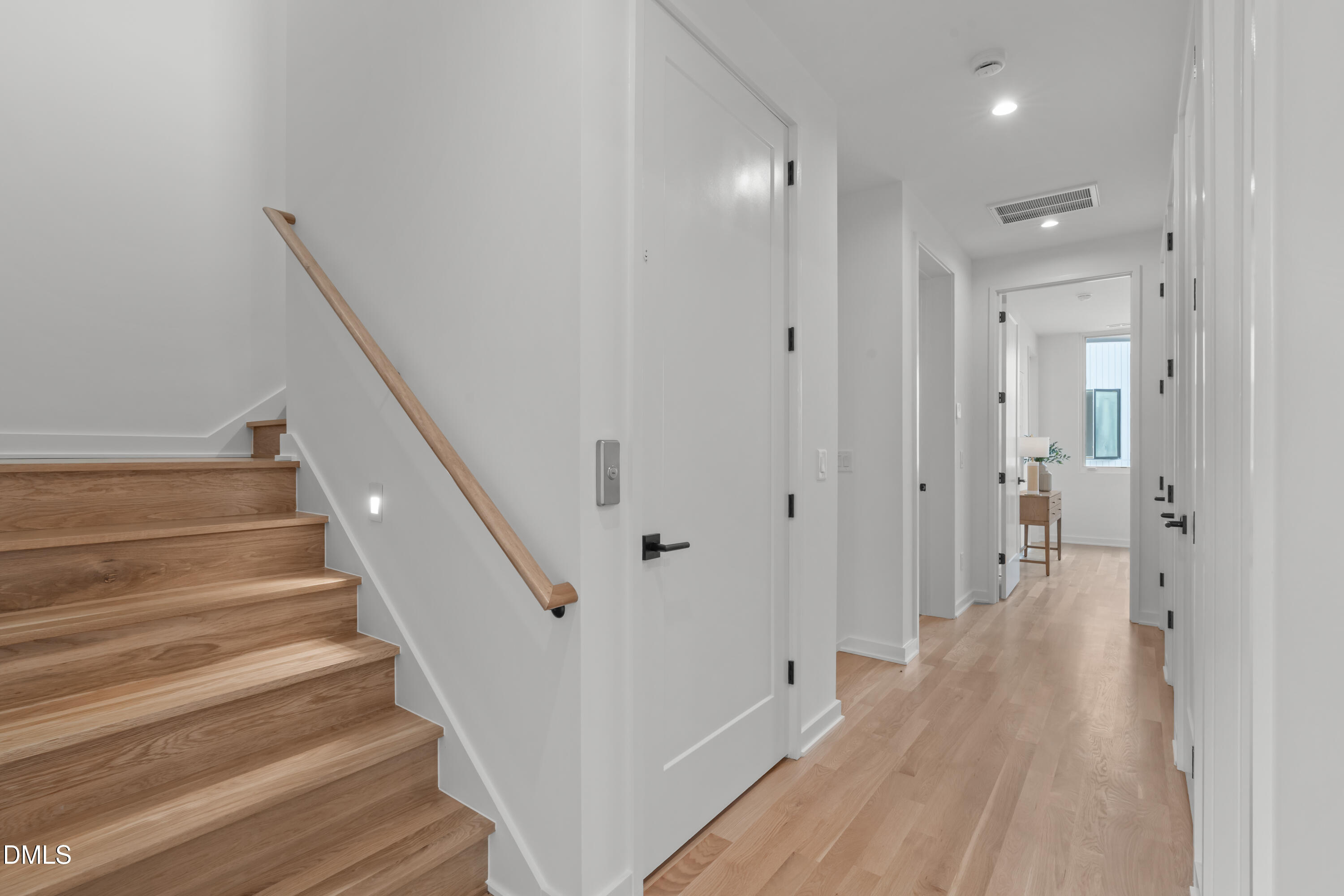 1307 Chamblee Hl Court Raleigh, NC 27608 - Photo 24 of 65 a view of a hallway with wooden floor and staircase