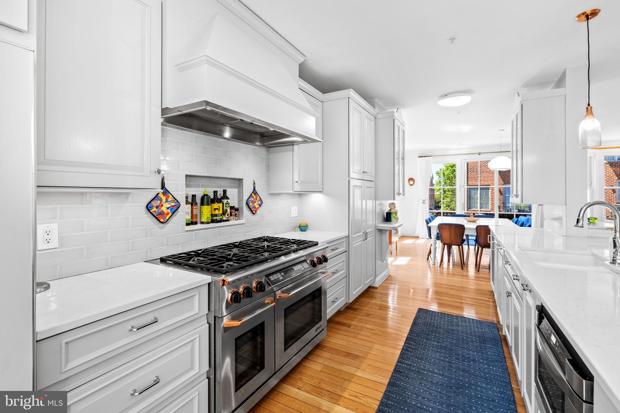2331 Boston Street, Unit 1 Baltimore, MD 21224 - Photo 34 of 74 a kitchen with stainless steel appliances granite countertop a stove and a wooden floors