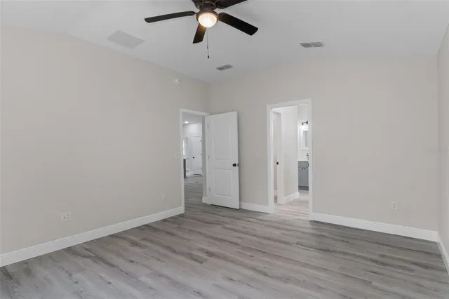 a view of a room with wooden floor