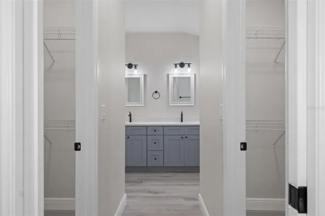 a bathroom with a sink double vanity and mirror