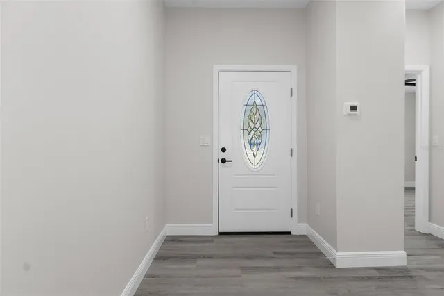 a view of front door with wooden floor