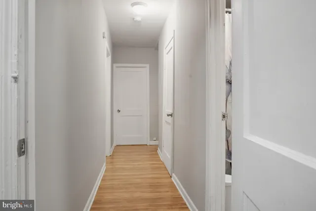 a view of a hallway with wooden floor