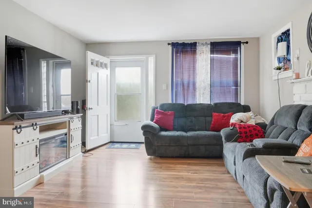a living room with furniture window and wooden floor