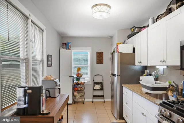 a kitchen with stainless steel appliances a stove refrigerator sink and cabinets